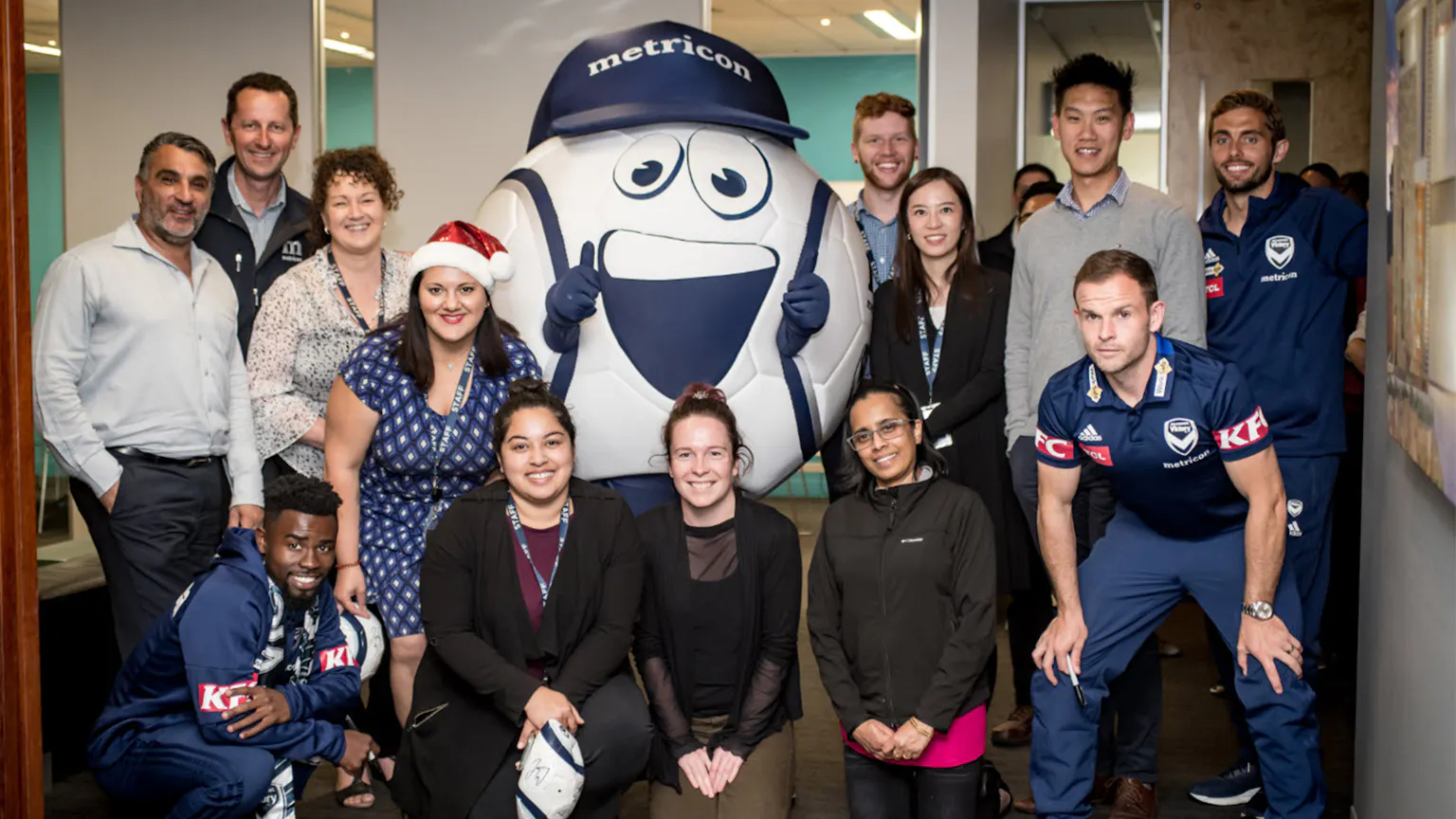 The Melbourne Victory team and mascot Kikka visited the Metricon offices to surprise the team with Christmas giveaways!