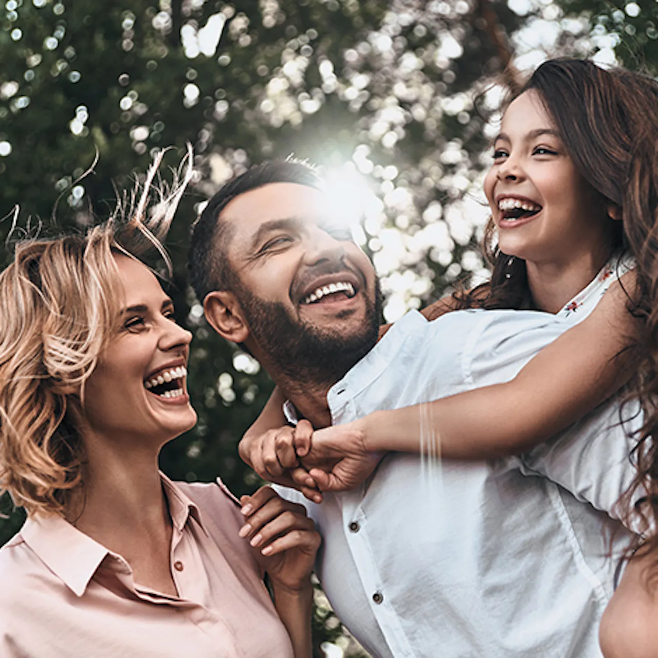 Wife, husband and daughter in a happy family photo.
